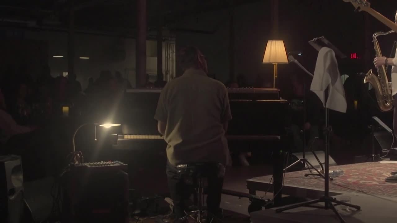 Pianist viewed from behind at the grand piano during Sympatico